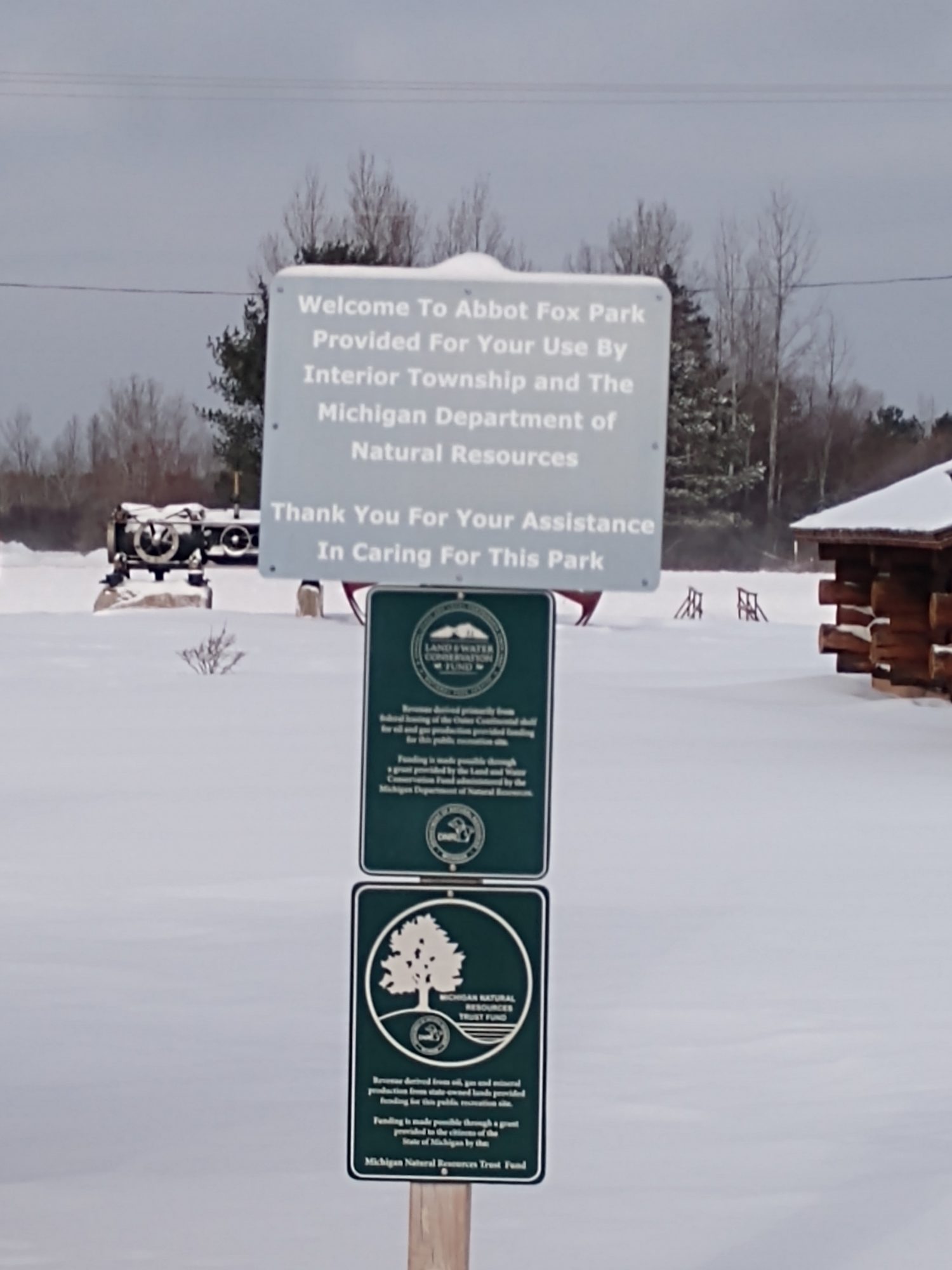 Signpost at Abbot Fox Park in snowy landscape.